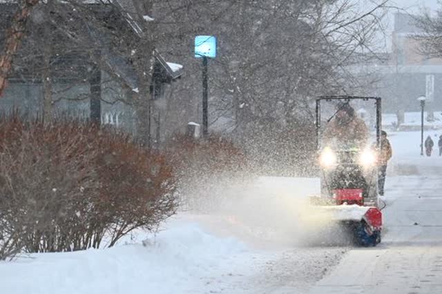 A plow clearing a snow-covered path